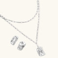 Modern textured hoop earrings and layered chain necklace with liquid metal pendant in silver and gold finishes.