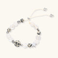 Adjustable beaded bracelet with spotted dalmatian stones, clear quartz crystals, and silver star charm on white background.