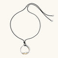 Minimalist silver and gold circle pendant on black adjustable cord, featuring eco-friendly zinc alloy construction