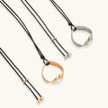 Minimalist silver and gold circle pendant on black adjustable cord, featuring eco-friendly zinc alloy construction