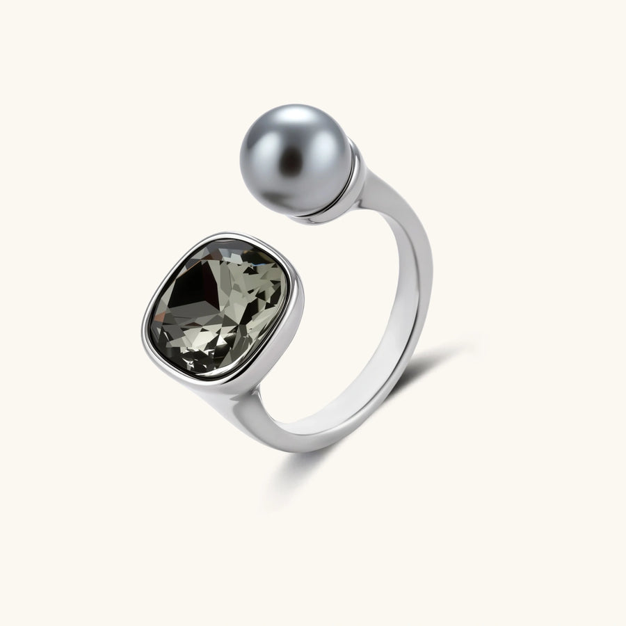 Modern adjustable ring with smoky zircon stone and metallic sphere in platinum-plated copper finish on neutral background.