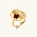 Close-up of brushed 18K gold-plated ring featuring red nanhong stone in geometric square setting with adjustable band